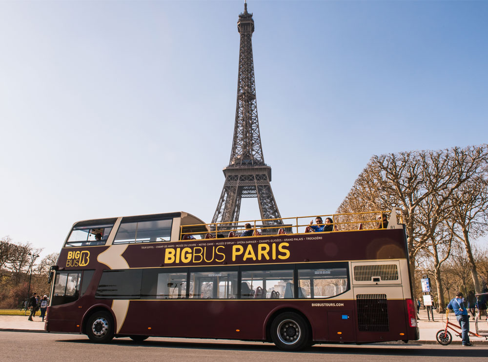 Big Bus Tour parked in front of Eiffel Tour in Paris