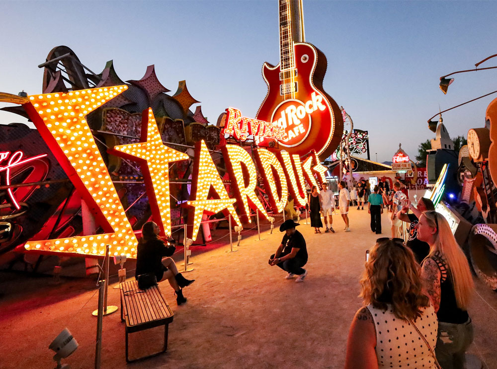 People taking pictures in front of a sign at the Neon Museum in Las Vegas