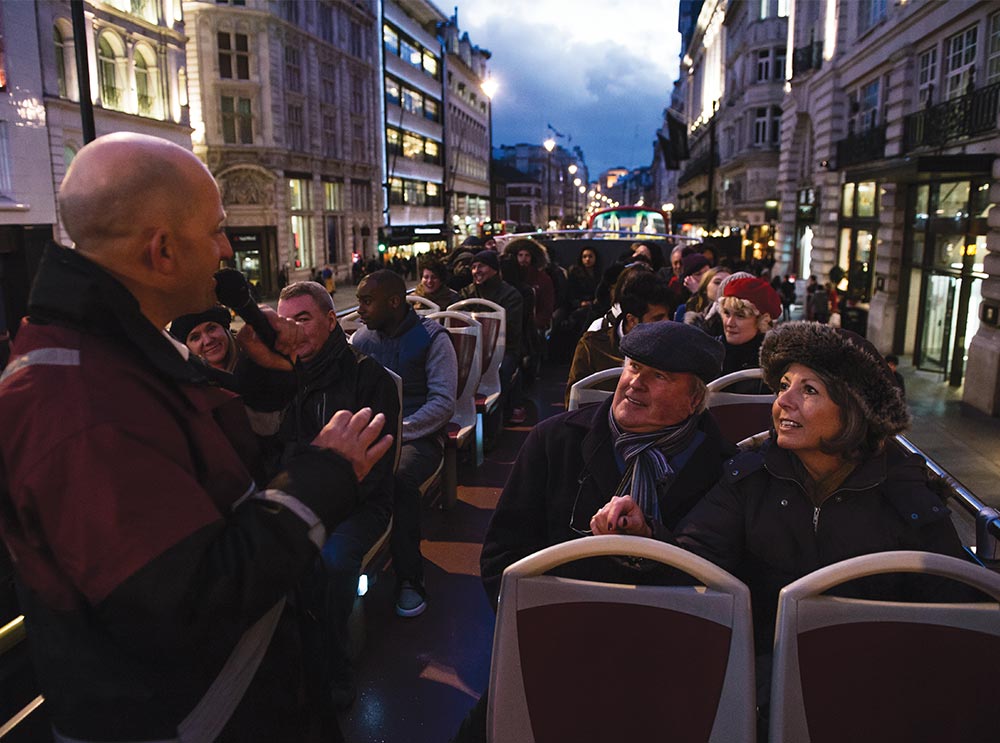 A live guide telling a story on the Big Bus Tour in London