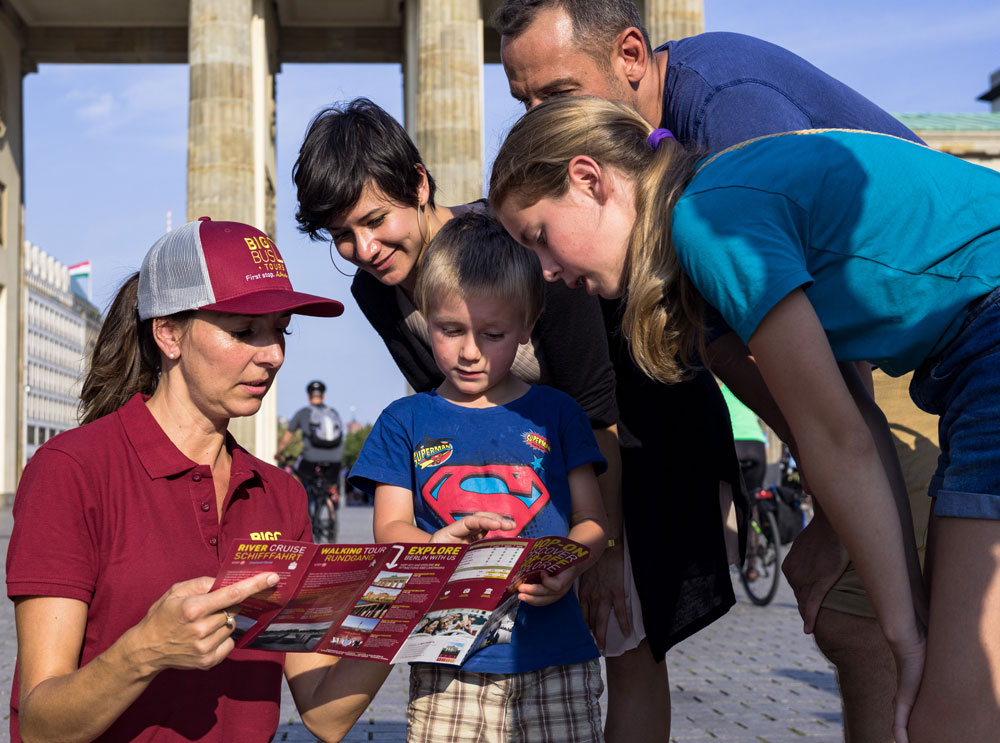 A family talking to a Big Bus Tours customer representative