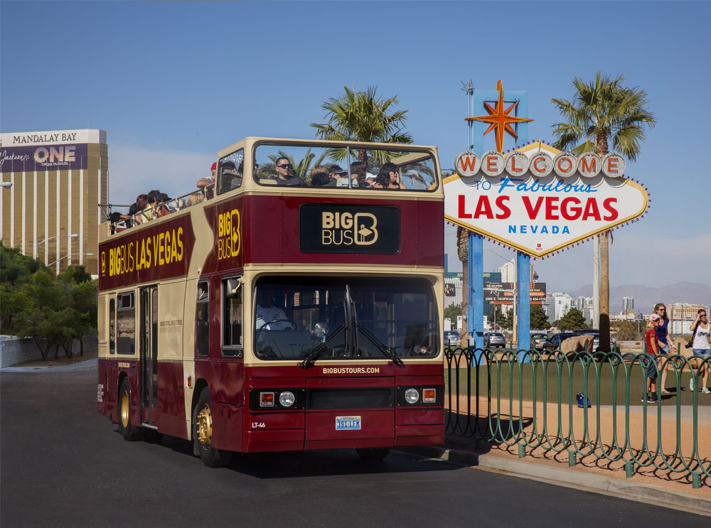 Big Bus in Las Vegas, next to the iconic Las Vegas sign 