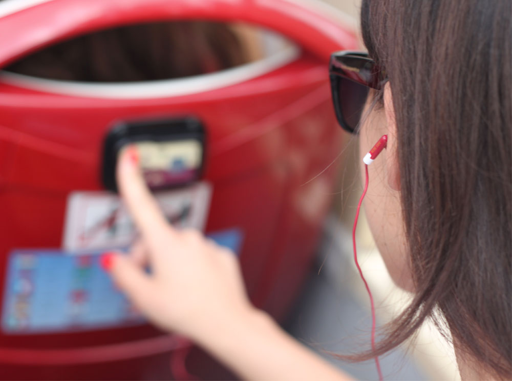 Woman listening to audio guide through earphones