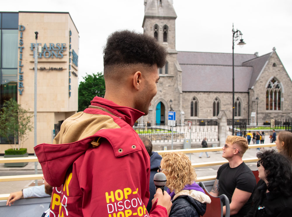 Live guide talking to passengers on an open top bus tour