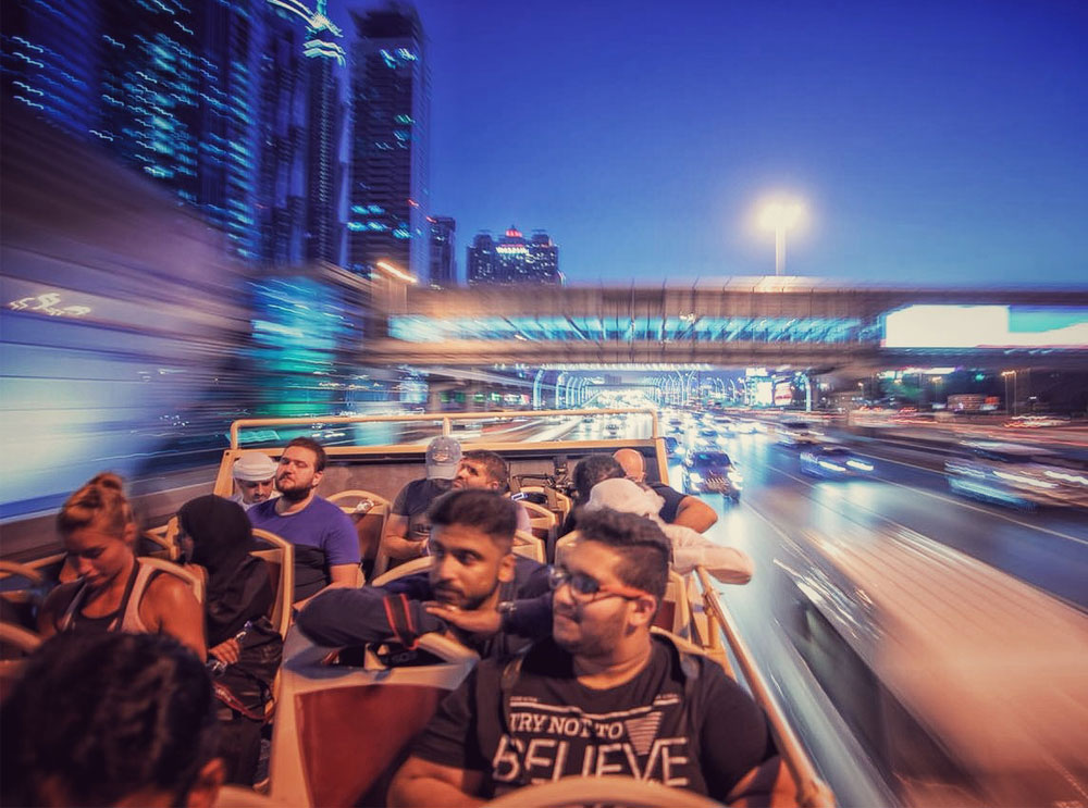 Passengers on open top sightseeing tour