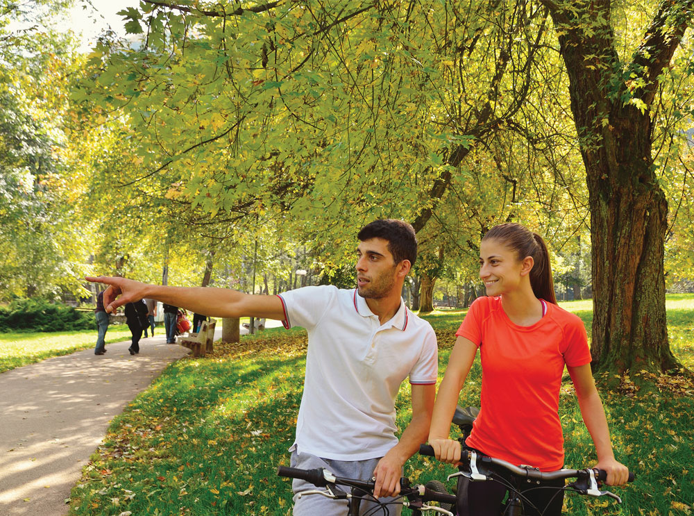 Couple riding bikes in a park