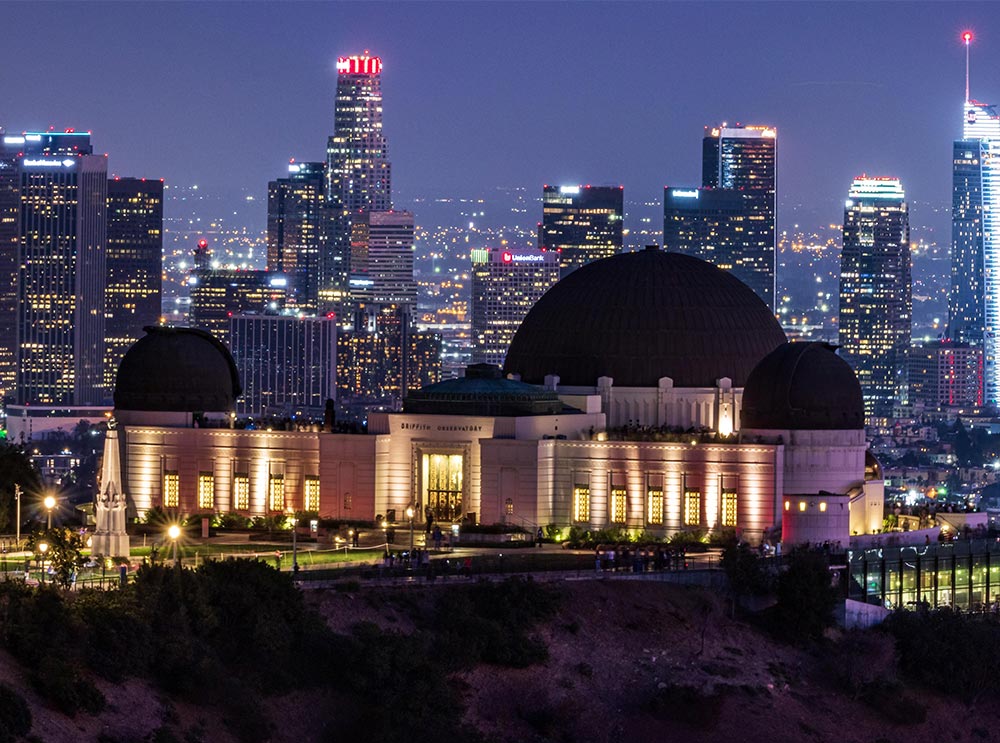 Griffith Observatory at night with the city view in the background