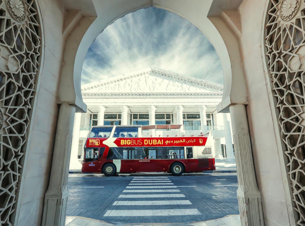 Big Bus Tours framed by a traditional Arabian archway