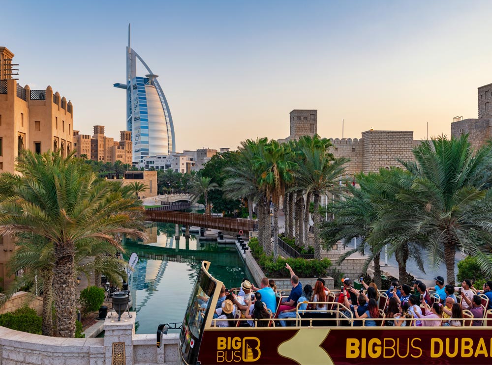 Big Bus Tours Dubai with Burj Al Arab in the background