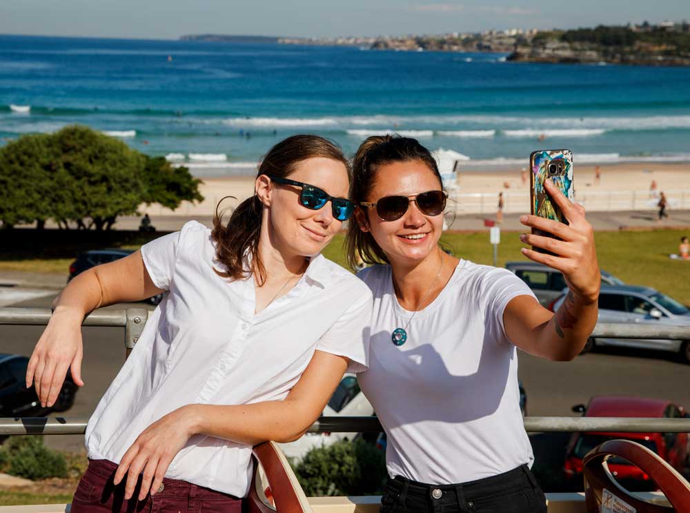 Friends on board with Big Bus Tours Sydney at Bondi Beach