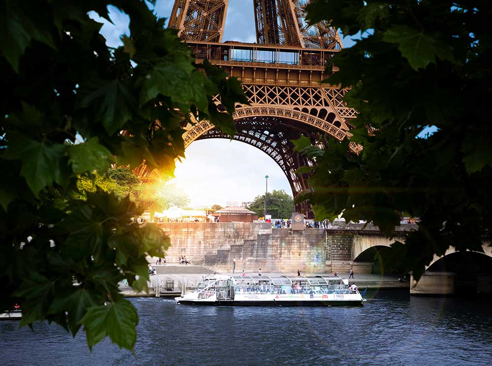 Hop-on Hop-off boat cruise docked at the Eiffel Tower