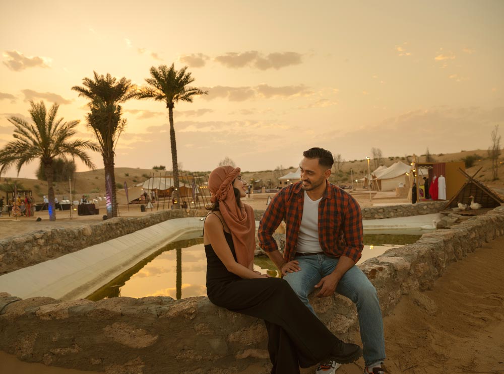 A couple relax at Caravanserai Desert Camp