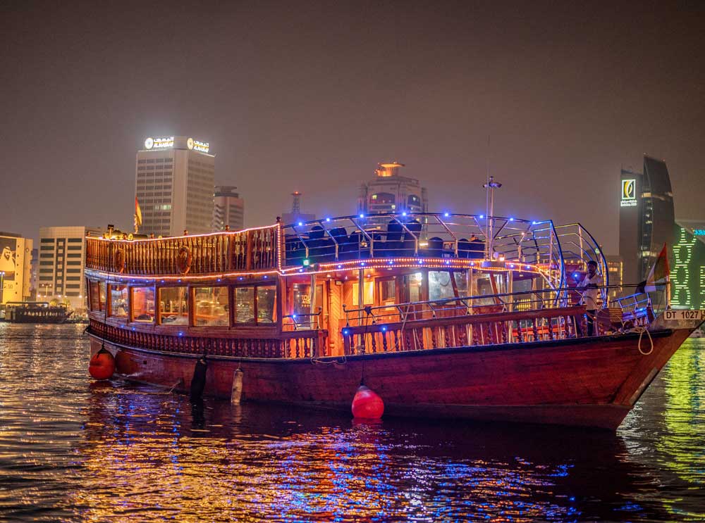 Dhow cruises along Dubai Creek at night