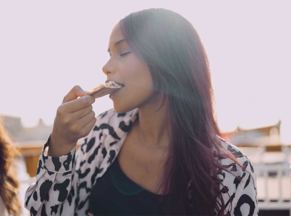 Woman enjoys a slice of pizza