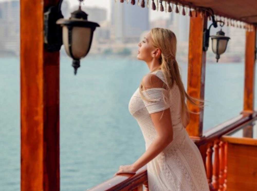 A woman relaxes on a Dubai Creek Dhow cruise