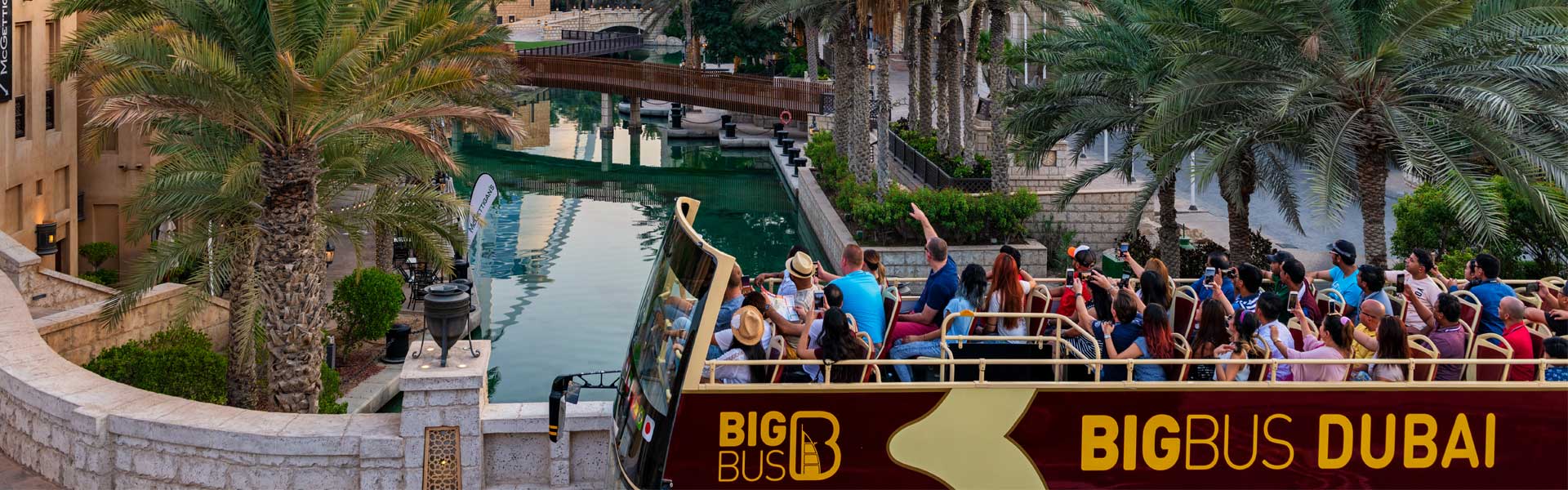 Tourists on Big Bus Tour passing Burj al Arab in Dubai