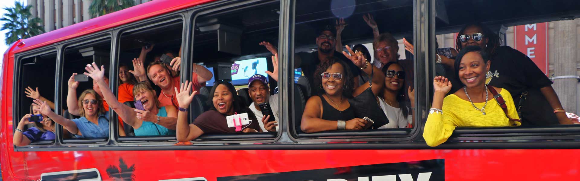 People enjoying a TMZ bus tour in Los Angeles